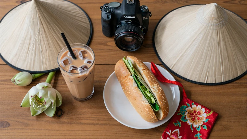 Vietnamese cultural items including ca phe sua da coffee non la hat banh mi and lotus flowers representing Vietnamese dating traditions