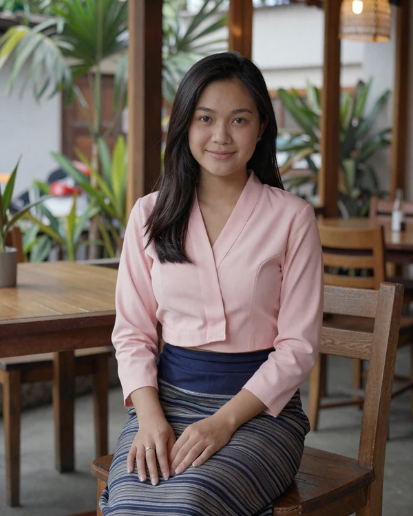Laotian woman smiling at a cozy cafe in Vientiane representing Lao women dating culture